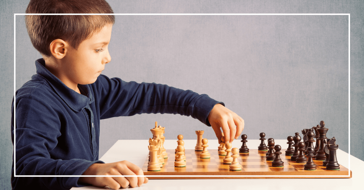 Concentrated serious boy developing chess gambit, strategy ,playing board  game to winner clever concentration and thinking child while playing chess.  Learning, tactics and analysis concept. Free Photo